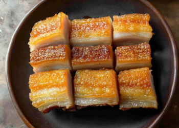Delicious Chinese crispy pork belly with a golden, crunchy skin.