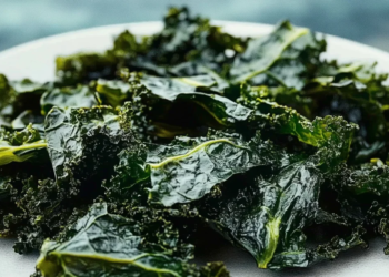 Bowl of crispy kale chips seasoned and ready to eat