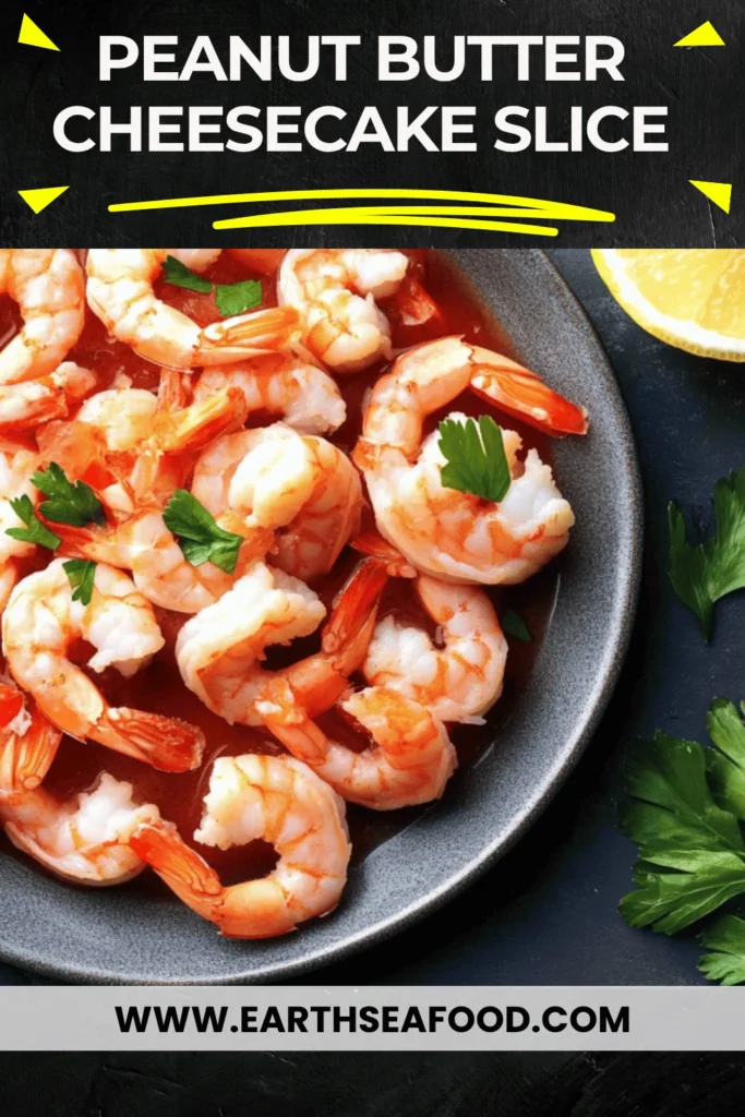 A delicious shrimp cocktail served in a glass with zesty sauce and lemon.