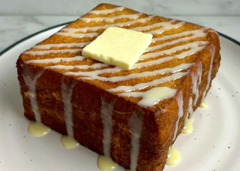 Hong Kong French Toast served with syrup and butter on a plate.
