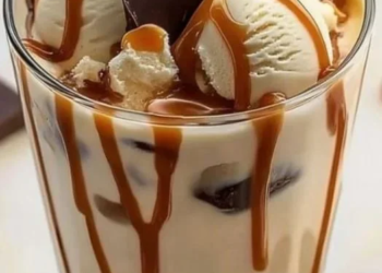 Bowl of homemade Moose Tracks Ice Cream with chocolate fudge and peanut butter cups.